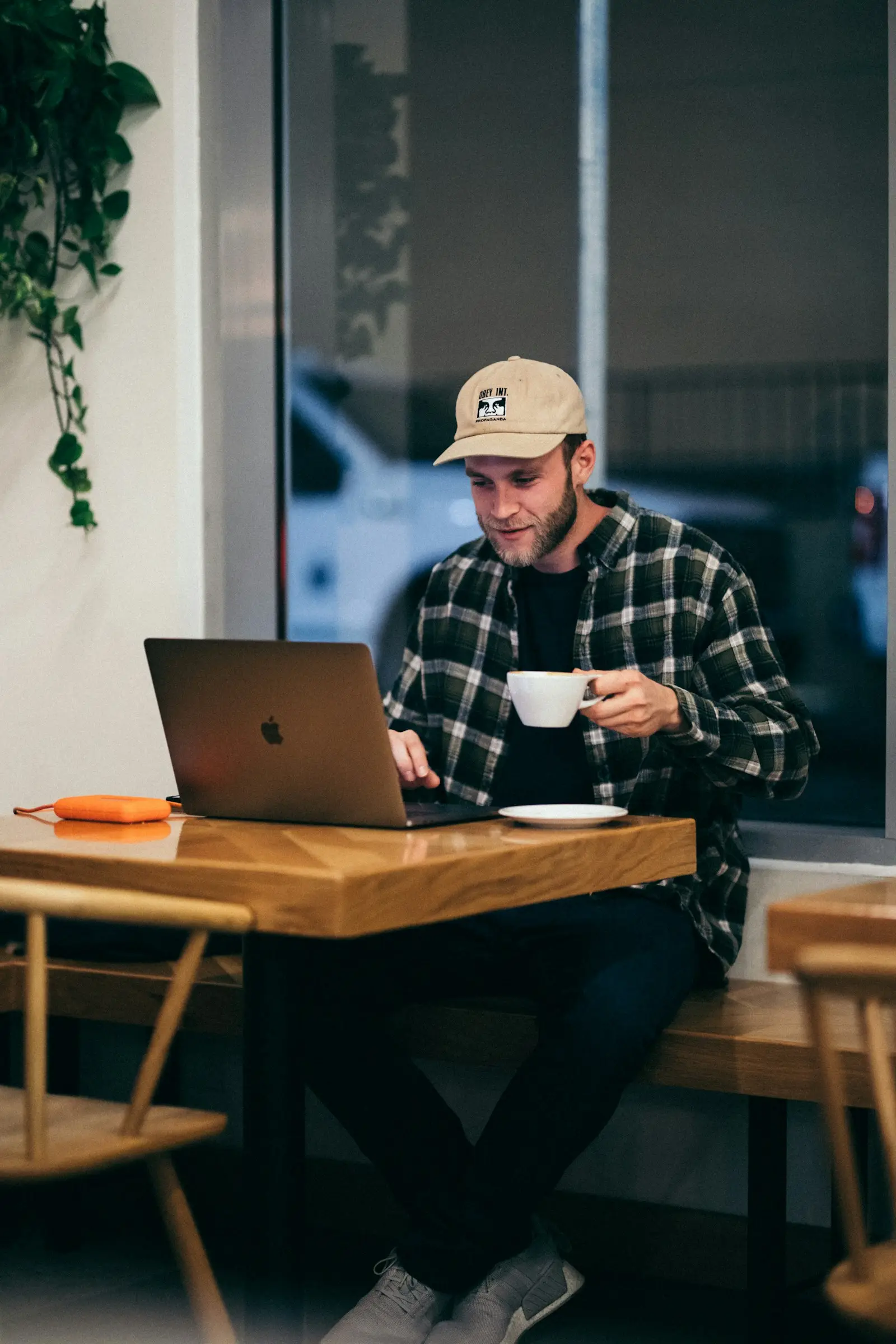 A digital nomad working from a specialty café, laptop open beside a carefully poured coffee